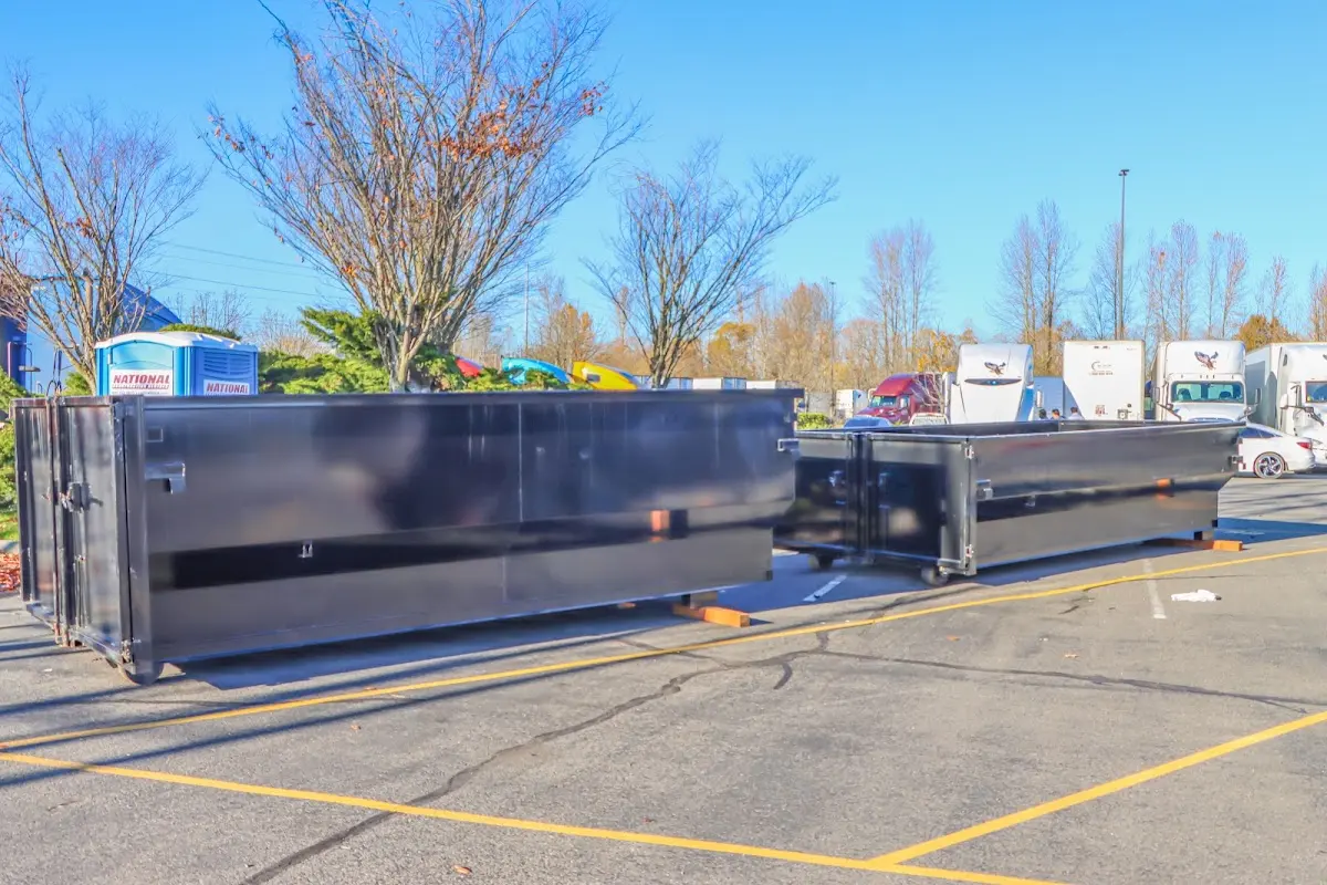 Professional dumpster rental service with roll-off container on residential driveway in Oak Hills